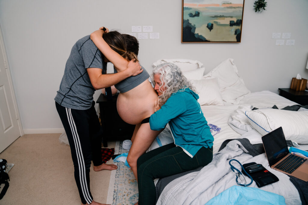 A doula does the double hip squeeze in labor.