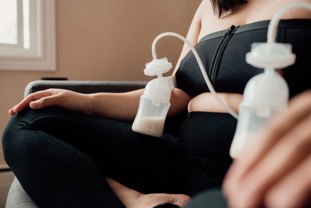 A woman hooked up to a doula breast pump.