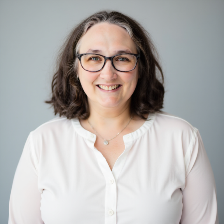 Robin Elise Weiss in a white shirt on neutral background.